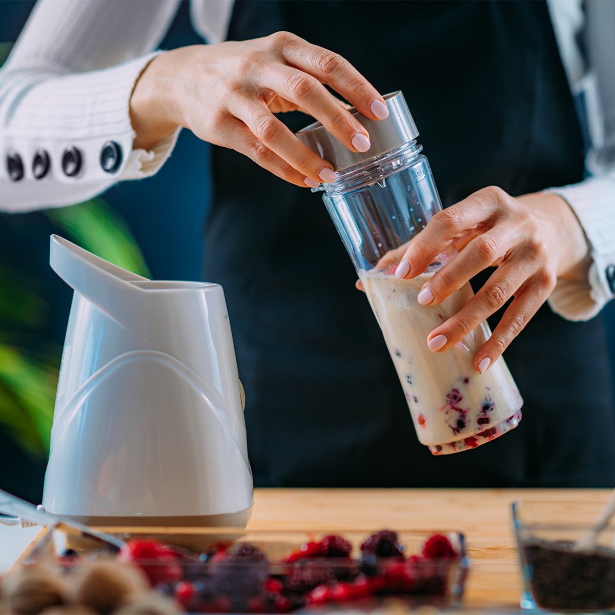 woman makes healthy shake in portable blender