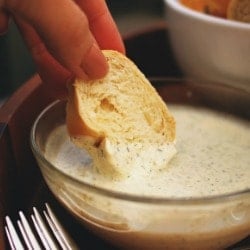 Dipping bread into Aioli