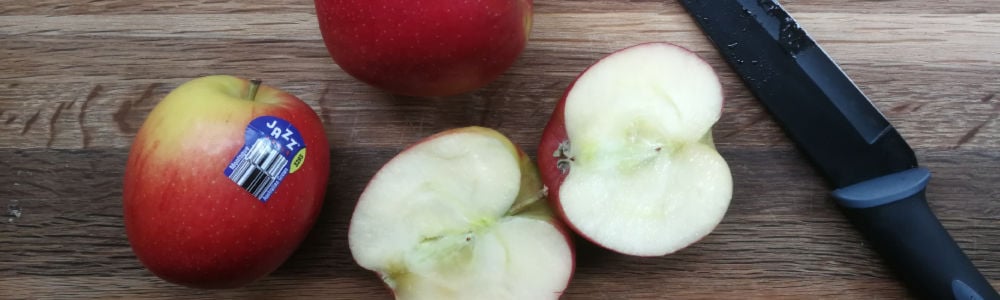 Jazz apples and a knife on chopping board