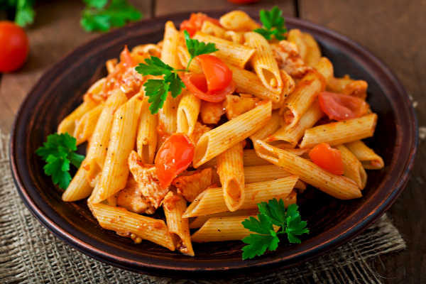 A plate of penne pasta with tuna and tomato sauce