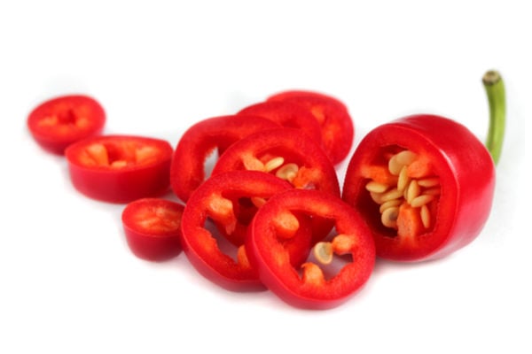 Sliced chili peppers on white background