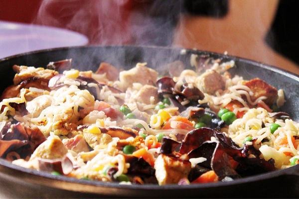 Frying pan cooking rice and vegetables