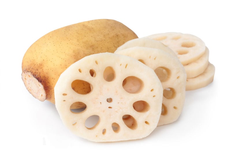 Freshly sliced lotus root on a white background