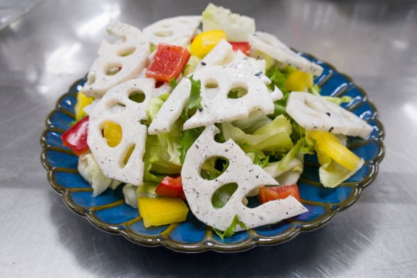 Salad with lotus root slices on a plate