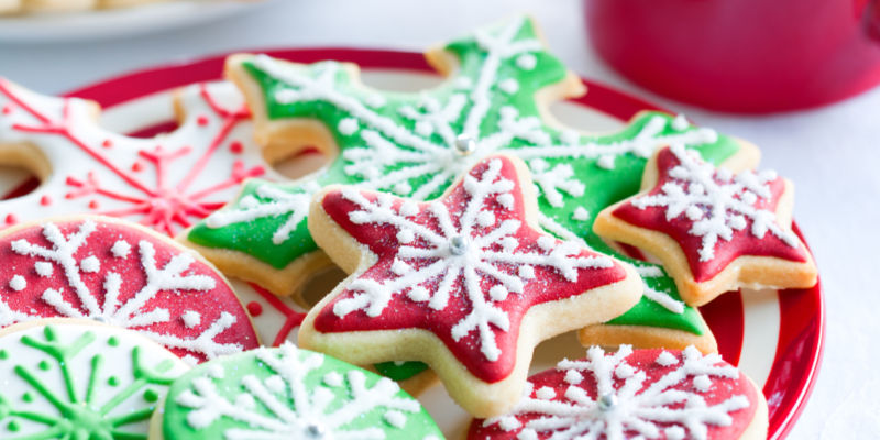 Christmas cookies shaped like stars sitting on a plate.