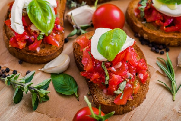 Bruschetta topped with herbs