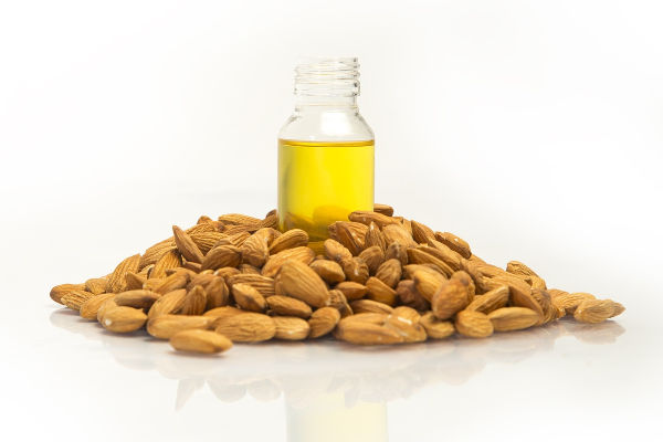 Almond oil next to almonds
