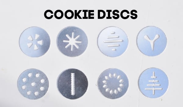 8 cookie press discs on a white background.