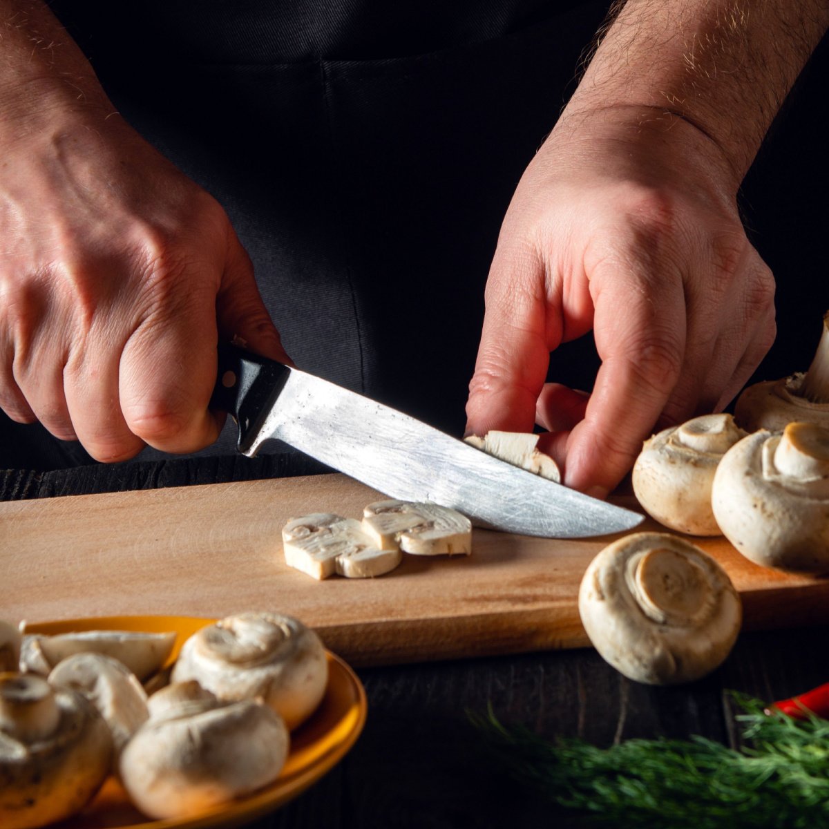 chef cutting mushrooms