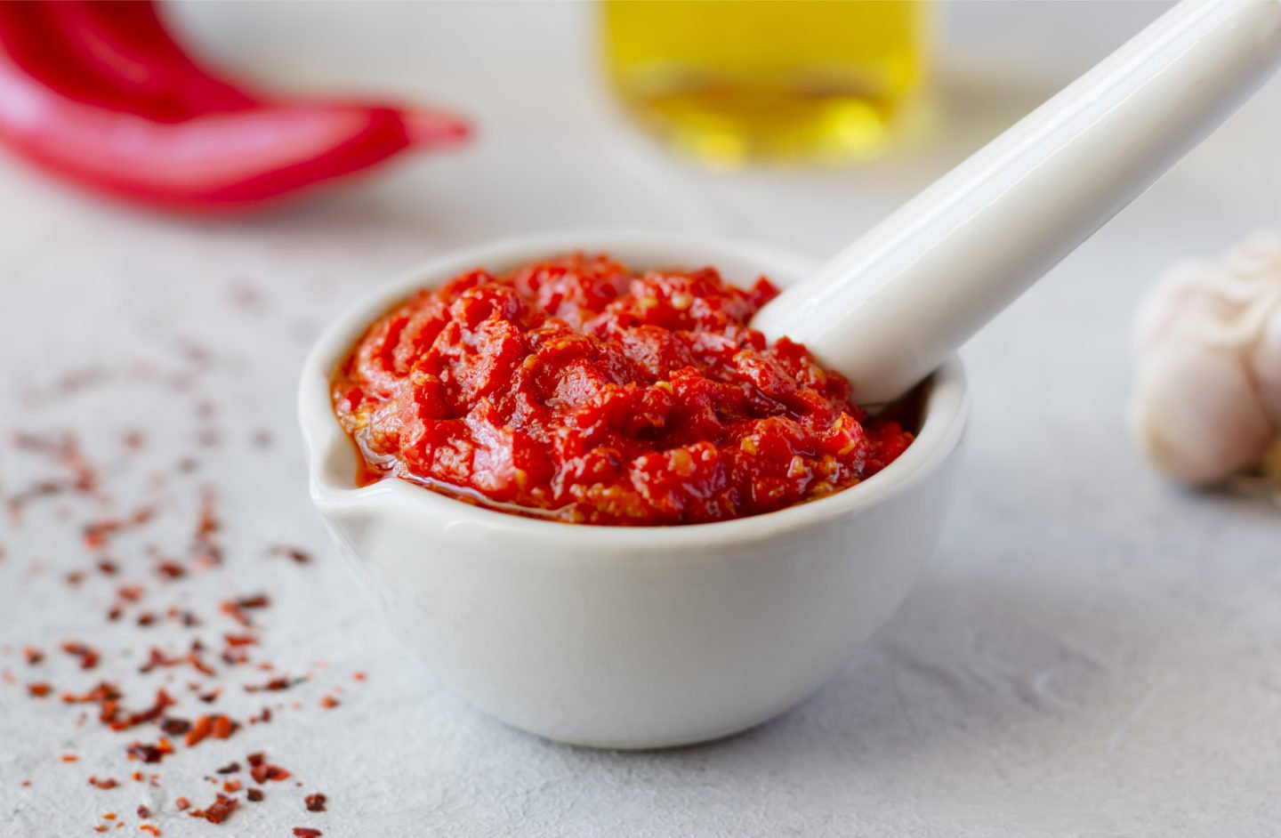 grinding harissa with mortar and pestle