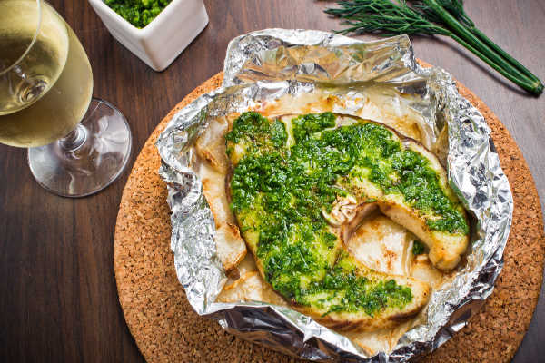 Pesto topped swordfish in foil