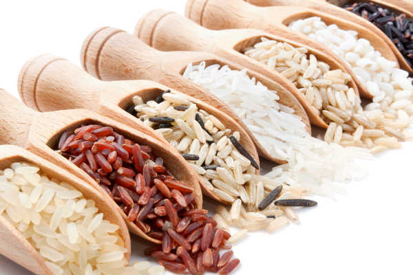Different types of rice in scoops.