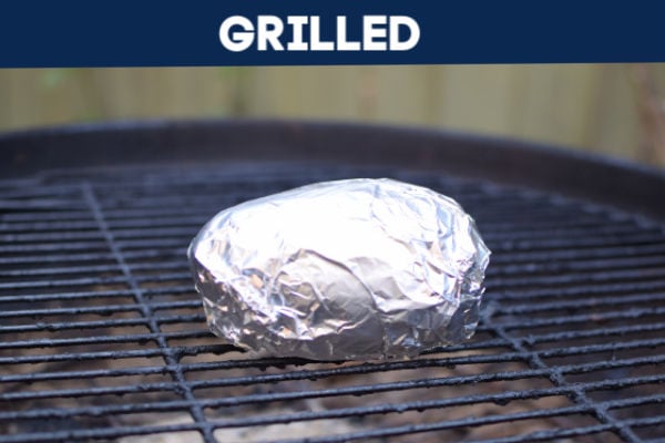 BBQ with a potato wrapped in foil