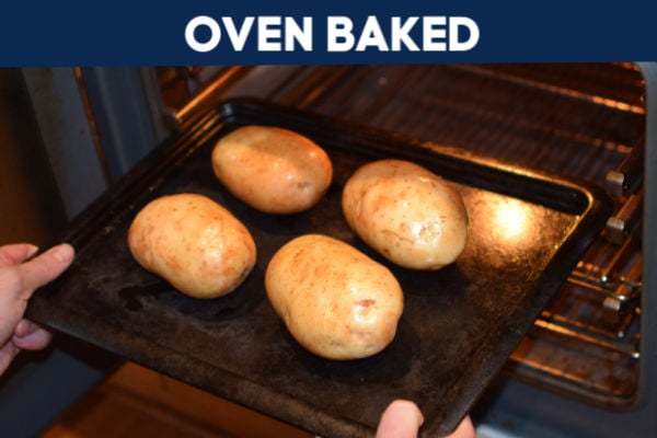 An oven tray with baked potatoes