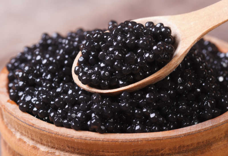 Black caviar in a spoon.