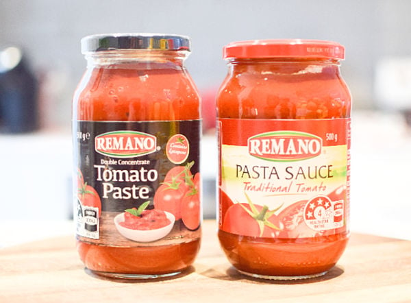 Jars of sauce and paste on a board