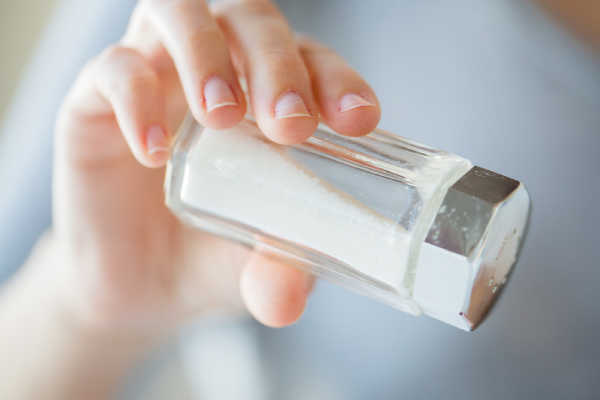 Pouring salt into a pan of water