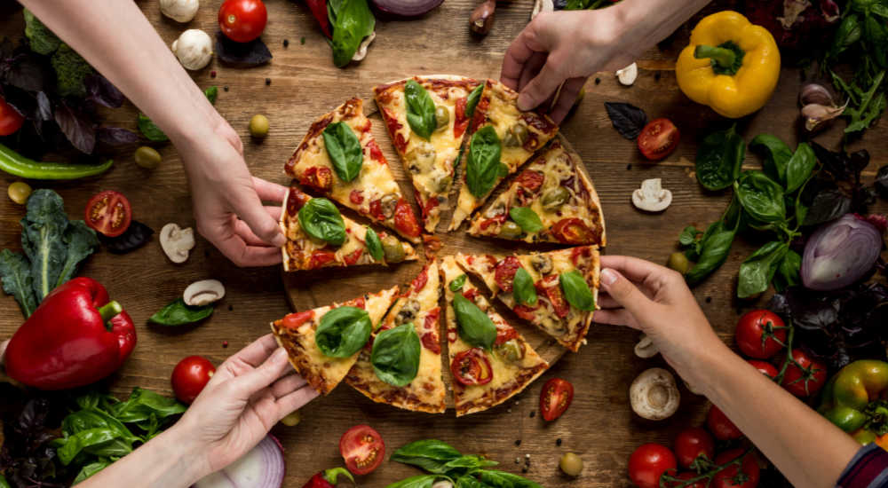 Cooked pizza on a board ready to be eaten