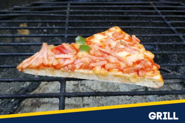 A slice of pizza on a grill reheating