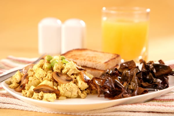 A plate of scrambled eggs and dulse, with toast and juice.