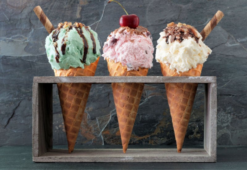 Cones scooped with ice cream in a wooden stand