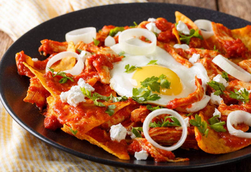A bowl of Chilaquiles on the table