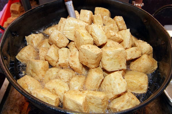 Fried stinky tofu in a wok