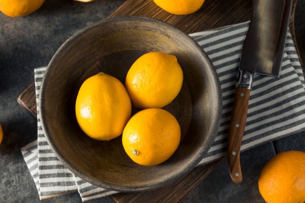A bowl of Meyer lemons on the table
