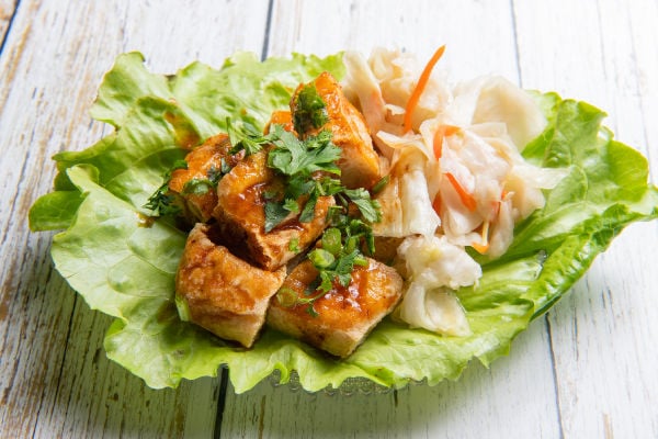 A lettuce leaf holding stinky tofu