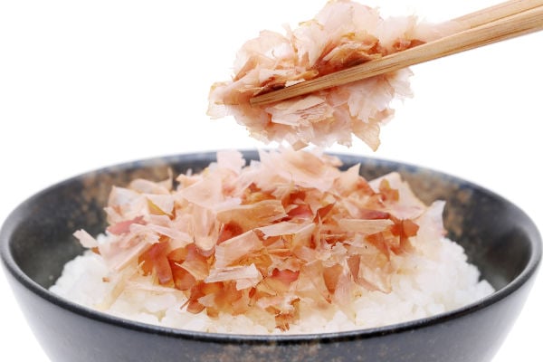 Bonito flakes on top of rice in a bowl