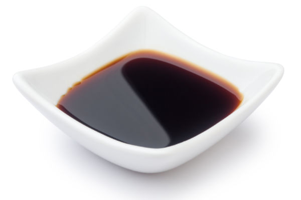 A white bowl of soy sauce