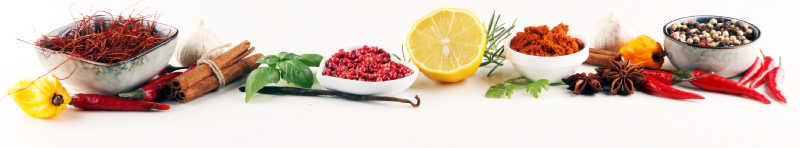 A selection of herbs and spices on a white background