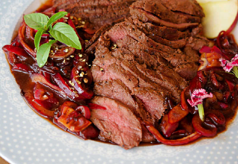 Sliced kangaroo meat on a plate.