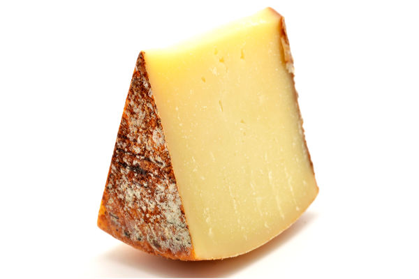 A wedge of pecorino on a white background