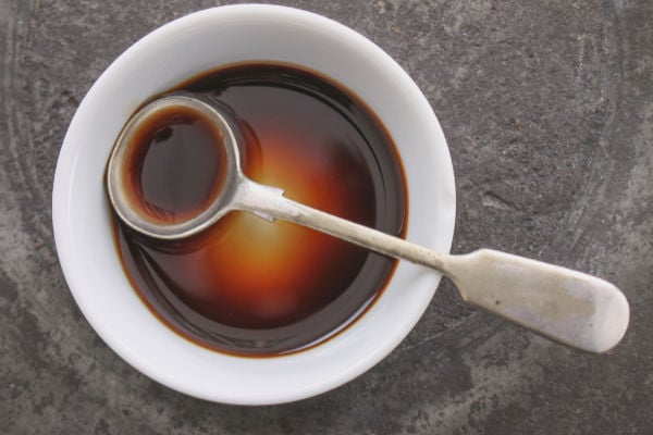 A bowl of worcestershire sauce and a spoon