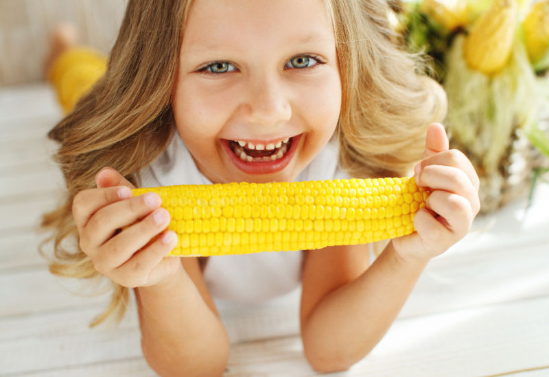 A girl eating corn