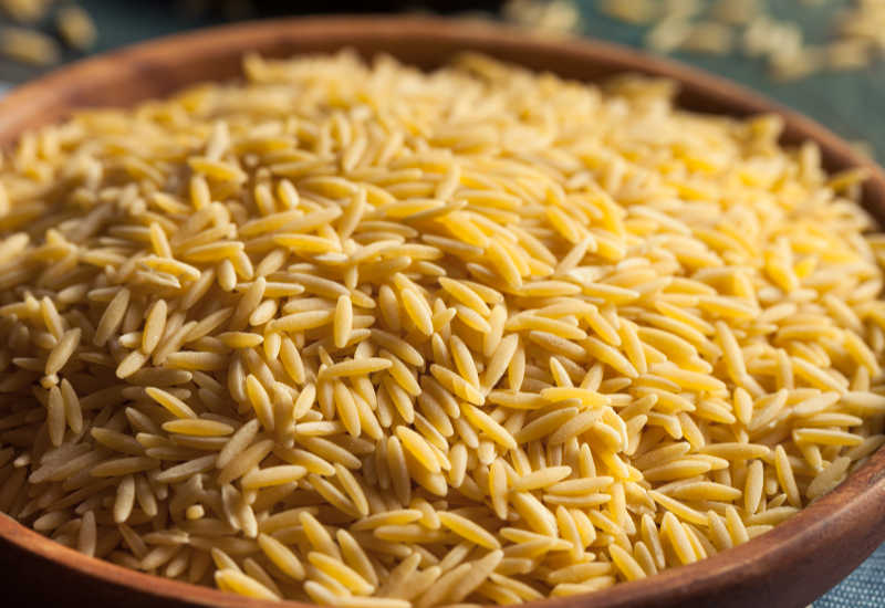 Raw orzo pasta in a bowl