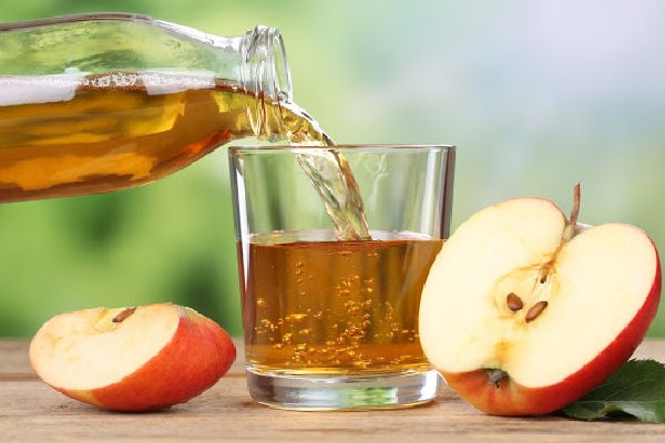 Pouring apple cider into a glass