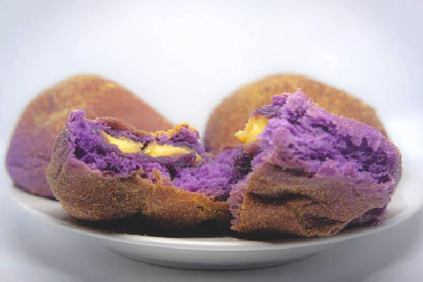 Ube pandesal filled with cheese.