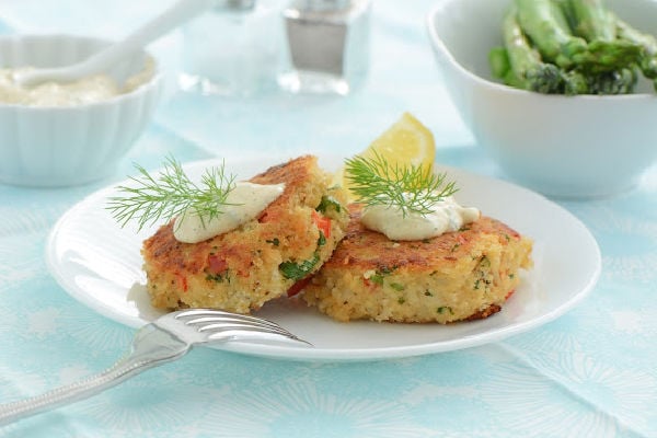 Crab cakes with sauce on a white plate