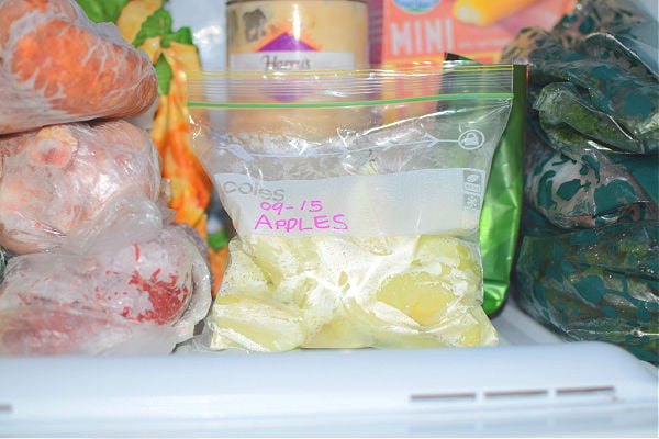 A zip-lock bag of sliced apples in the freezer