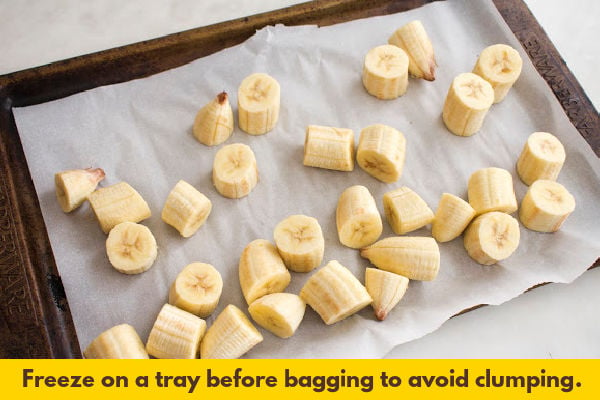 Slices of banana on a lined baking sheet