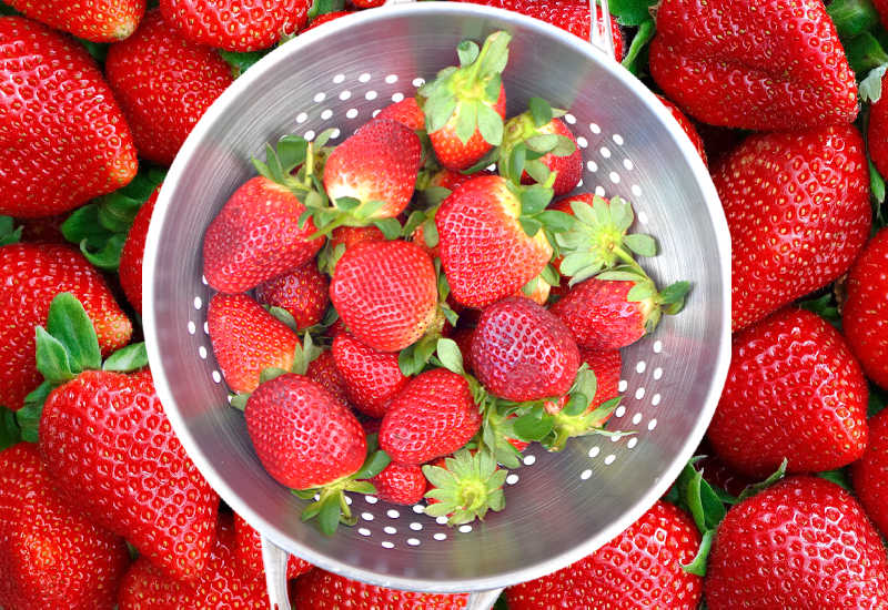 Fresh strawberries in a strainer