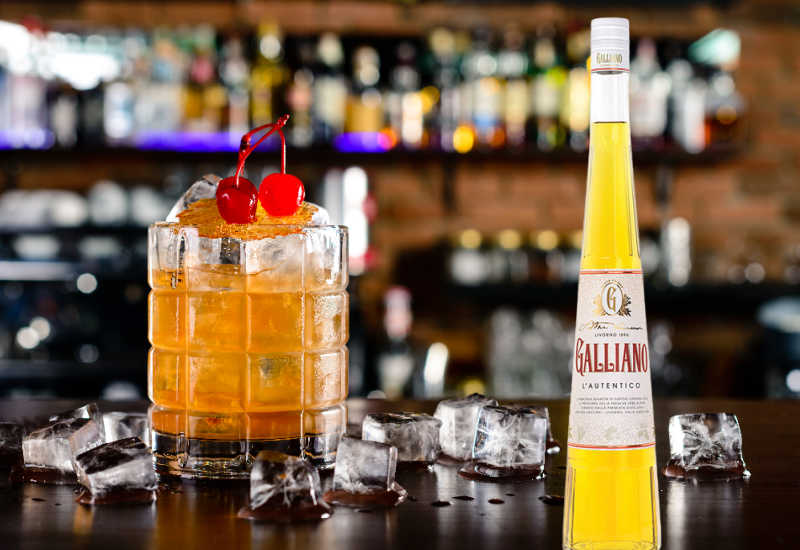 A Harvey Wallbanger next to a bottle of Galliano