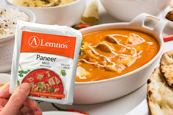 Holding paneer cheese in front of a curry