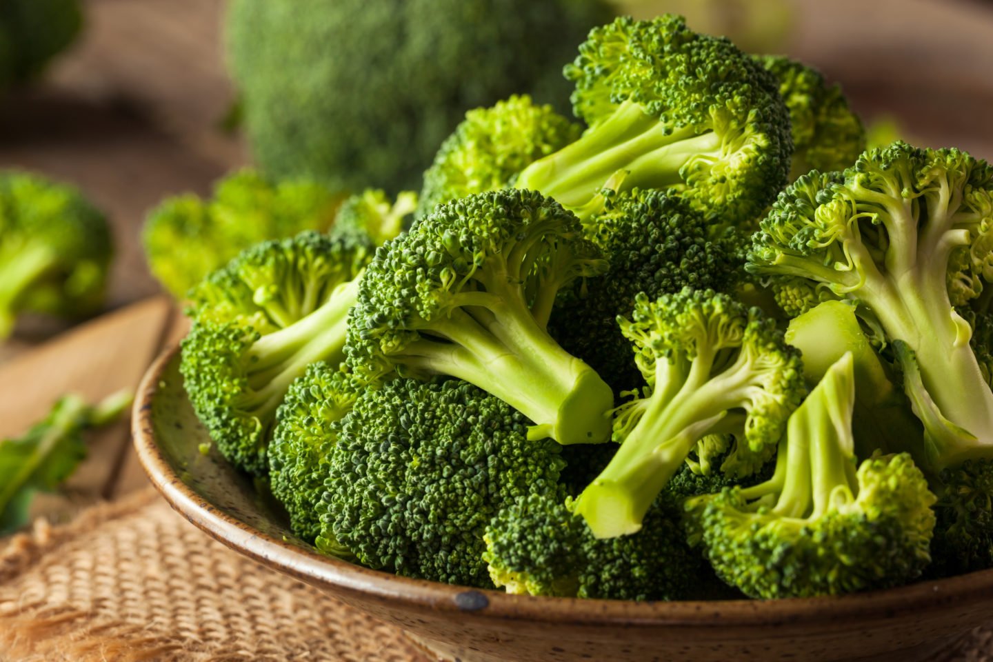 broccoli florets on a wooden plate