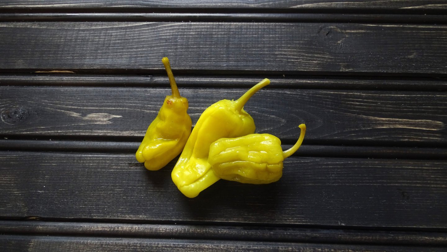 Fresh Pepperoncini On Wooden Surface