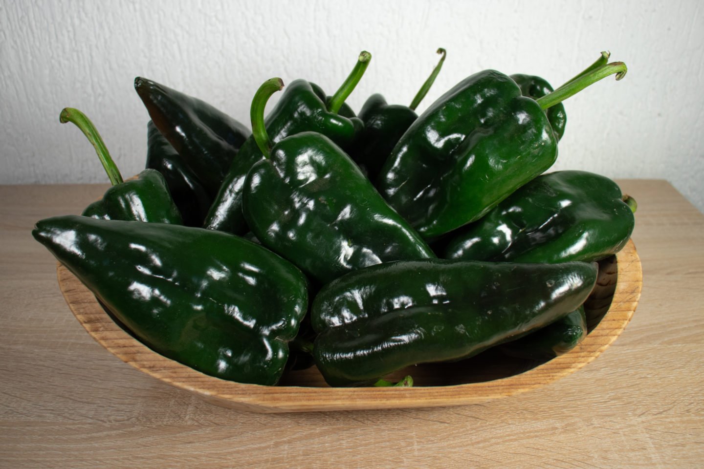 handful of poblano peppers in basket