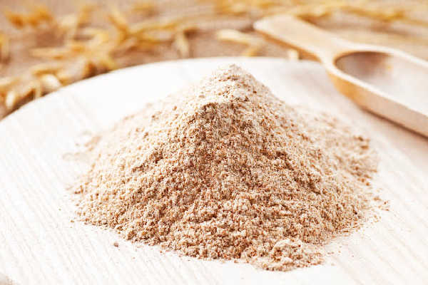 Millet flour in a pile on a board