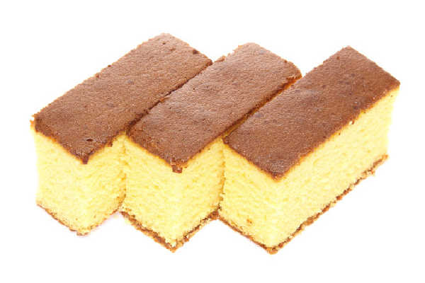 Slabs of sponge cake on an isolated white background